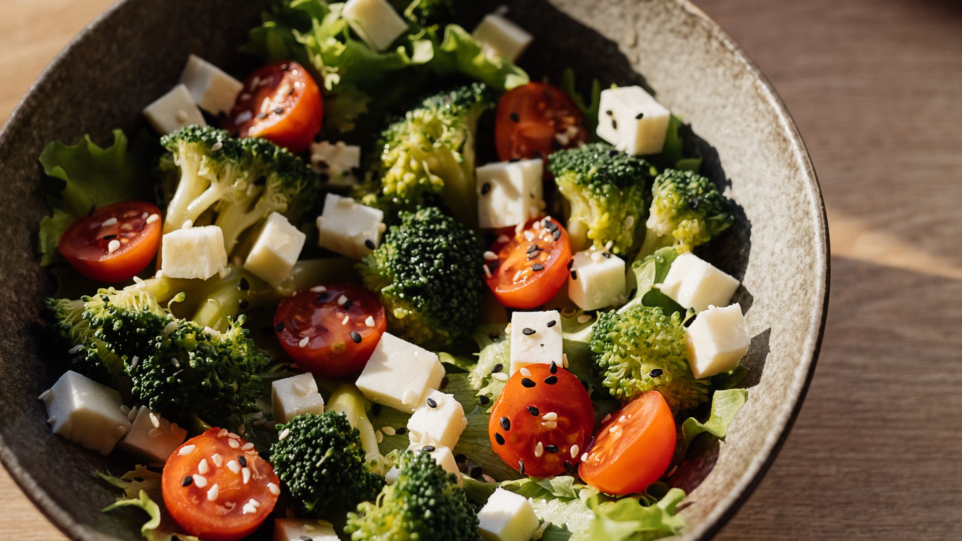 Bowl of broccoli, tomato, and cheese salad
