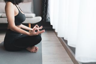 A woman meditating to de-stress