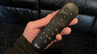 Klipsch Flexus Core 200 soundbar remote control held in reviewer's hand
