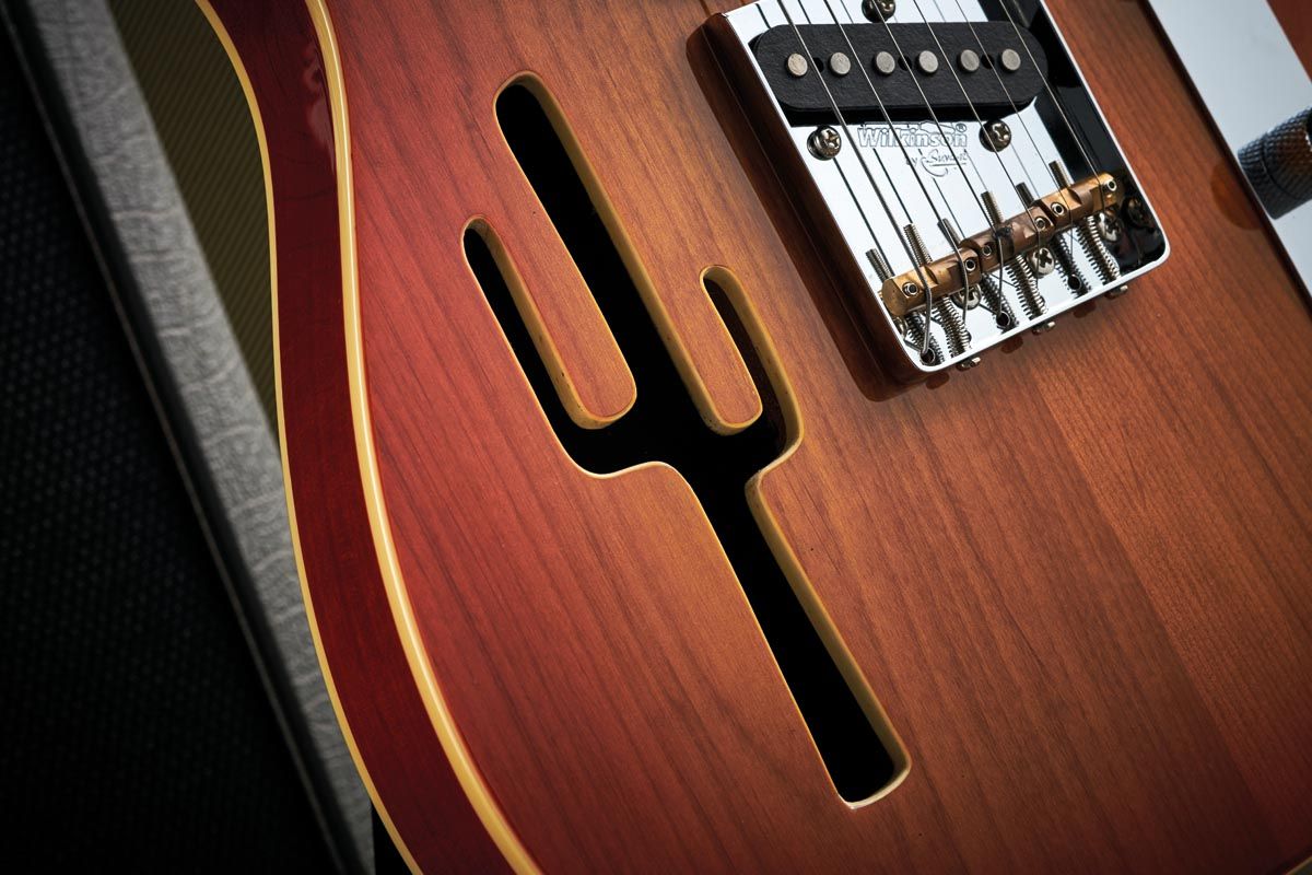 The Lucky Buck is a thinline model. In other words, its American alder body is semi-hollow making it lightweight and vibrant. The soundhole meets the country and western brief with a saguaro-cactus shape.