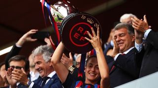 Alexia Putellas lifts the trophy after Barcelona Femeni win the Liga F title for the fourth year in a row in April 2023.