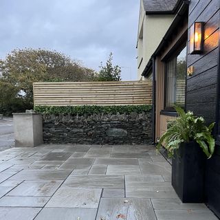 driveway with wood fence panels and timber cladding
