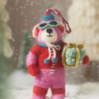 Handmade Felt Bear Ornament against a snowscape. 