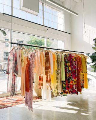 A rack of colorful clothes hangs in vintage store Arcade.