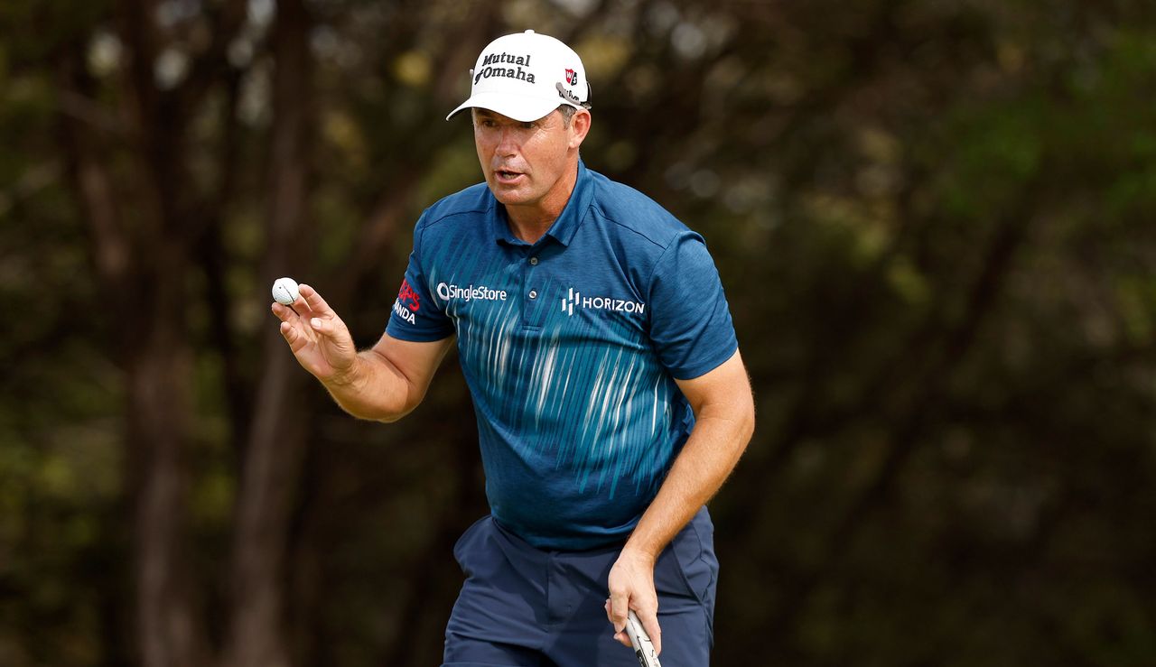 Harrington waves to the crowd whilst holding his golf ball