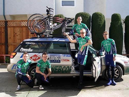 Webcor pose with their team car all racked up with their Specialized bikes