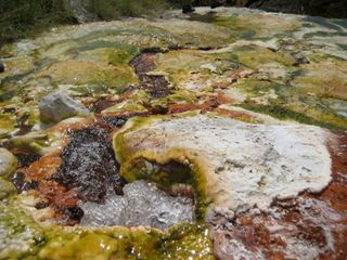 In volcanic areas like Tanzania's Rift Valley, the trapped helium can seep through weaknesses in the crust and bubble up through hot springs, like the one in this photo.
