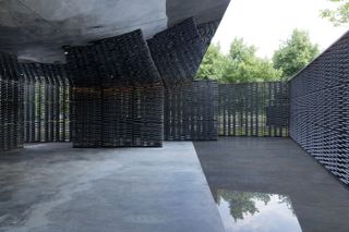 Serpentine Pavilion 2018 with concrete floor and lattice walls with reflective ceiling