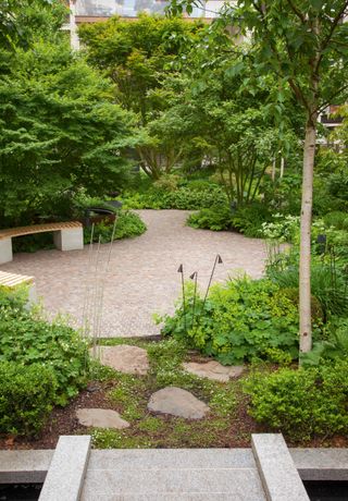 Modern garden with flower bed ideas and curved patio