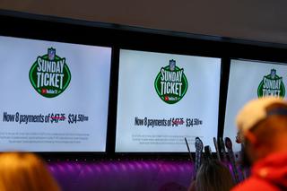 BUFFALO, NEW YORK - SEPTEMBER 05: An ad for NFL Sunday Ticket on YouTube TV is displayed as bar patrons watch the telecast of the game between the Kansas City Chiefs and the Los Angeles Chargers on September 05, 2025 in Buffalo, New York. (Photo by Aaron M. Sprecher/Getty Images)
