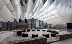 white cloths and black benches in vast venice hall