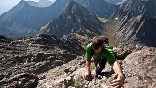 A man scrambles up a gully on the Crestone Needle in the Sangre de Cristo Mountains, Colorado