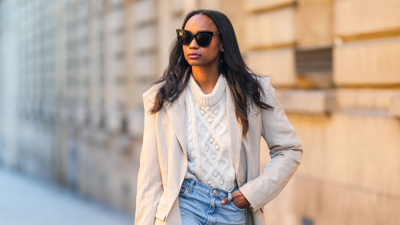 woman wears white cable knit sweater