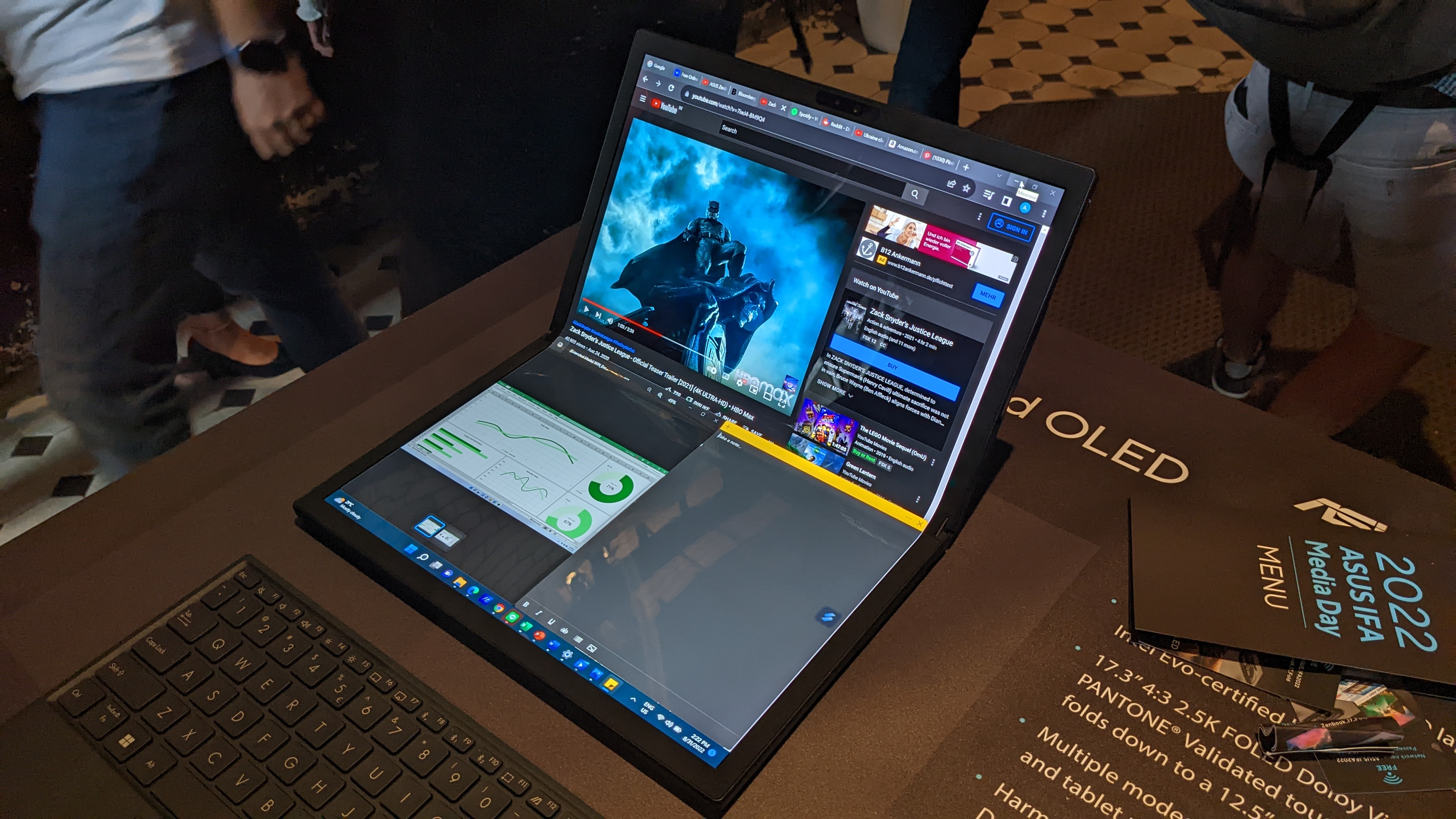 Asus Zenbook 17 Fold OLED foldable laptop on a desk at the Asus launch event.