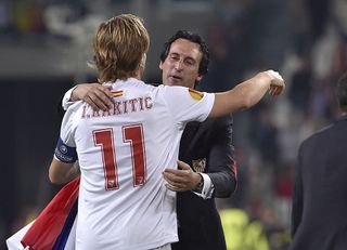 Sevilla's Croatian midfielder Ivan Rakitic (L) and Sevilla's coach Unai Emery celebrate after winning the UEFA Europa league final football match between Benfica and Sevilla on May 14, 2014 at the Juventus stadium in Turin. AFP PHOTO / MARCO BERTORELLO (Photo credit should read MARCO BERTORELLO/AFP via Getty Images)