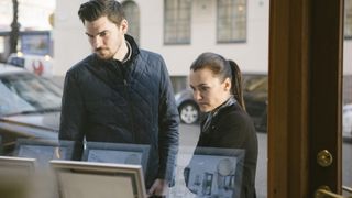 couple looking in an estate agent's window