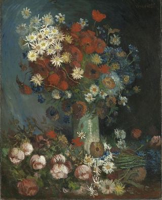 Color photograph of still life with meadow flowers and roses. Because of the additional bouquet of flowers in the foreground, doubters believe the work was too "busy" for a Van Gogh painting.