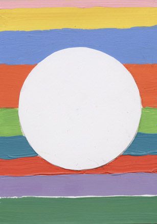 Striped coloured piece of paper with white circle in the middle