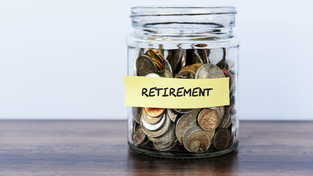 A clear jar has coins in it and is labeled Retirement.