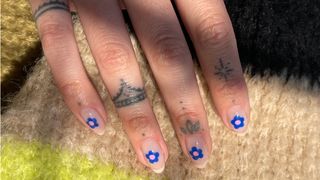 Blue daisy nail art on sheer base