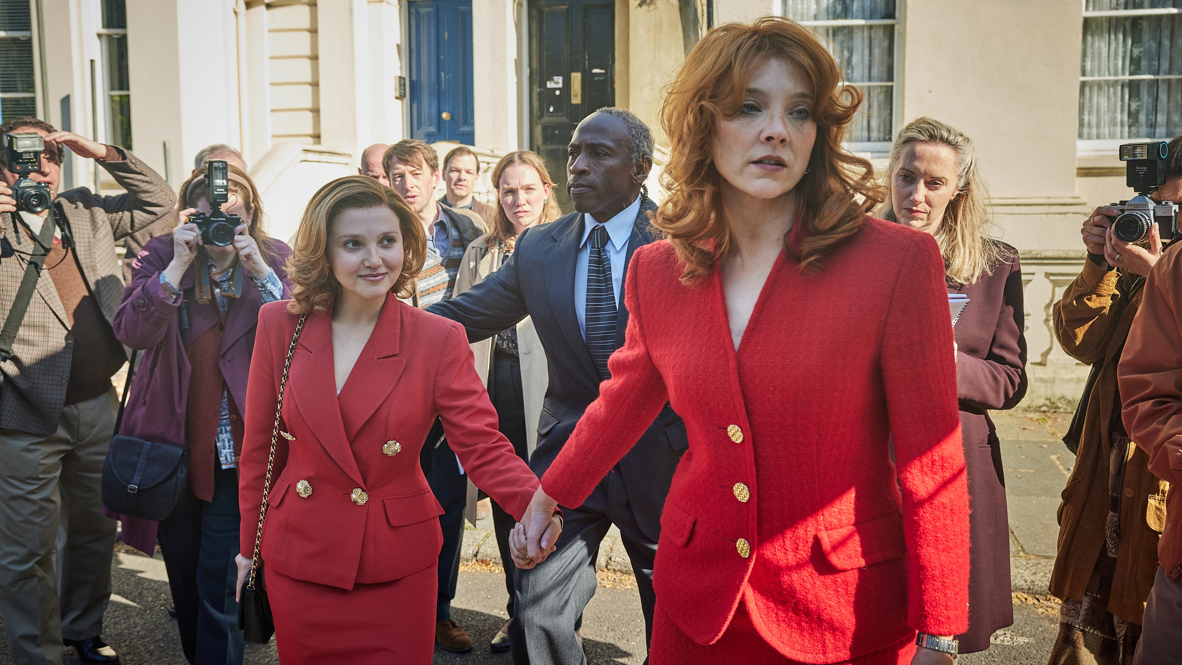 Mia McKenna-Bruce and Natalie Dormer play Jane Andrews and Sarah Ferguson, both wearing red blazers, in The Lady