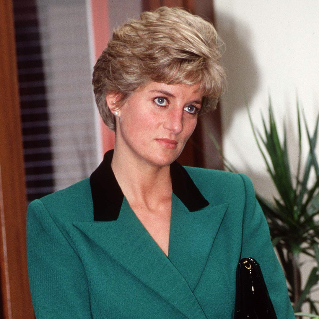Princess Diana wearing a green blazer and frowning