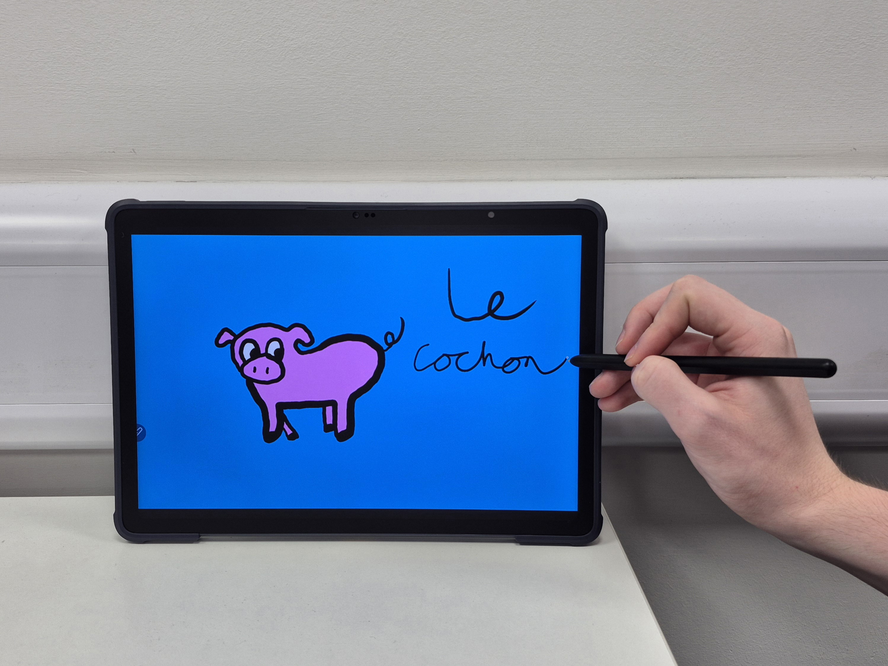 A picture of a tablet with a drawing of a pig