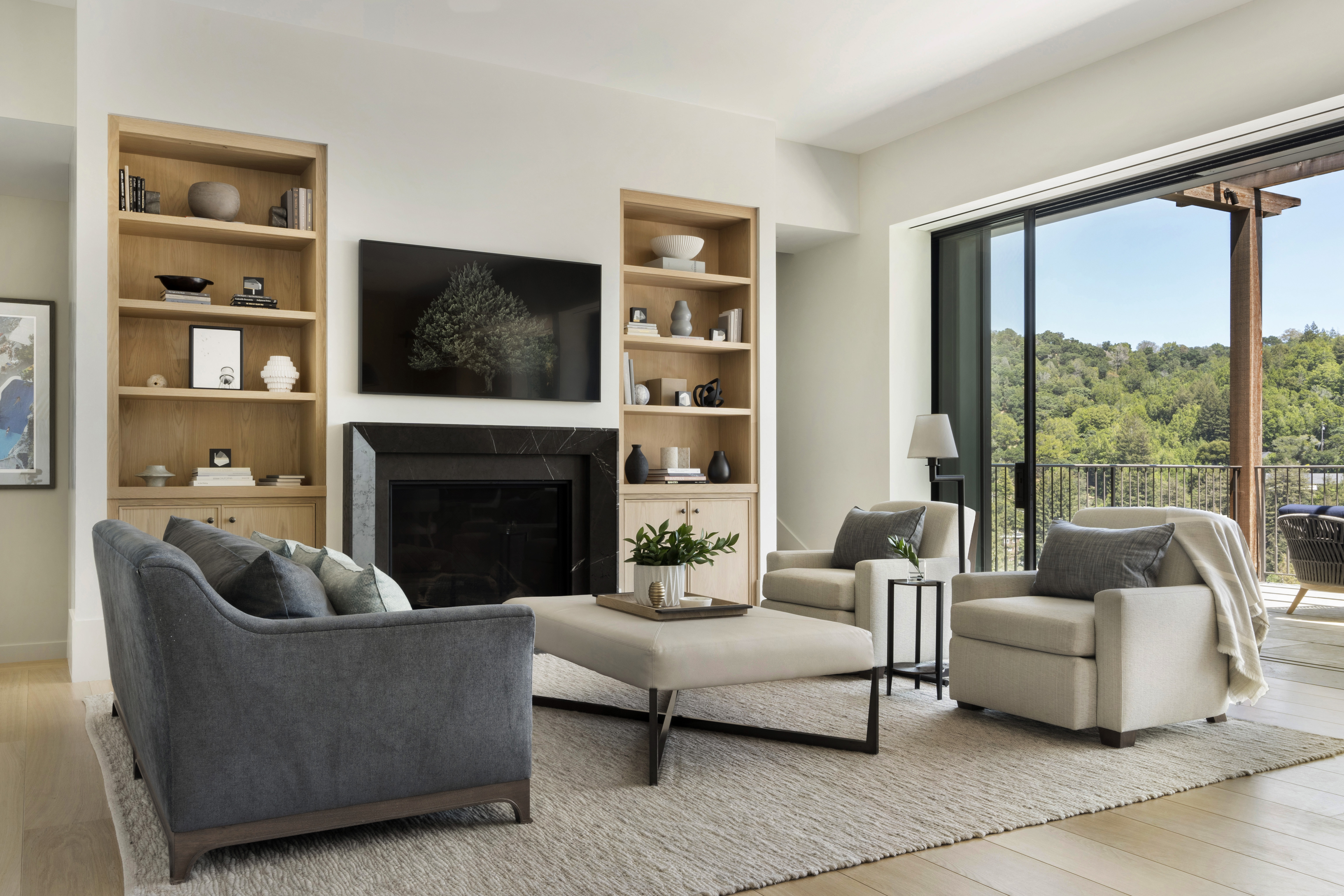 A contemporary living room with identical fitted shelving either side of the fireplace