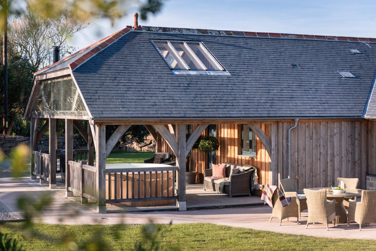 hipped roof extension to timber clad bungalow with veranda