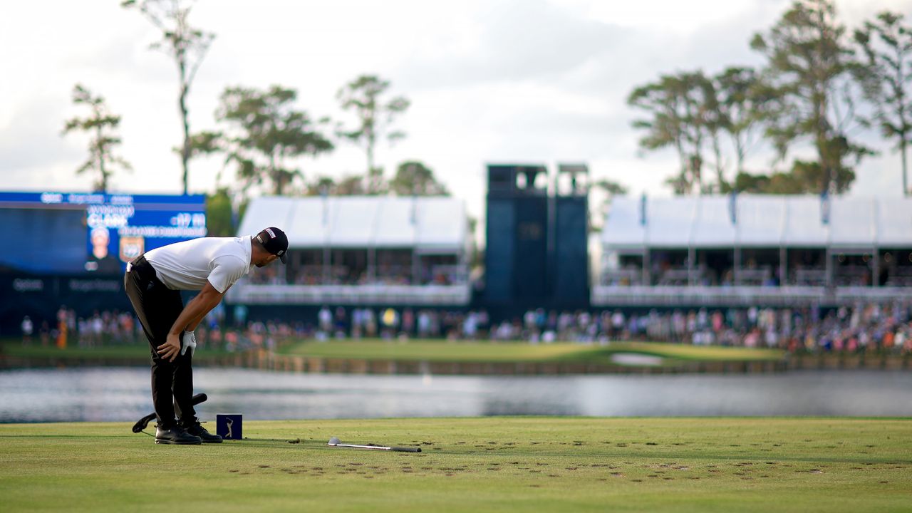 Wyndham Clark reacts after his ball lands in the water on the 17th at TPC Sawgrass