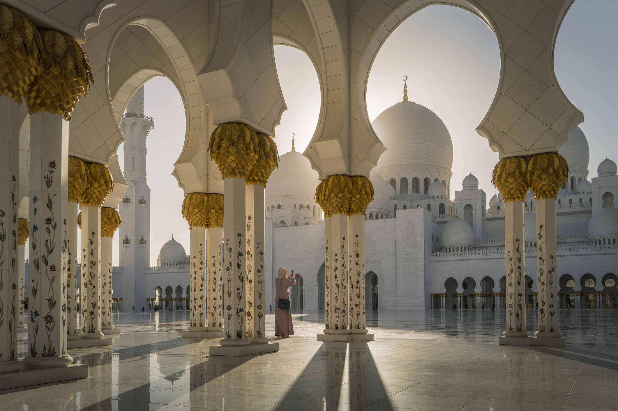 Woman with Abaya taking Pictures in a Mosque