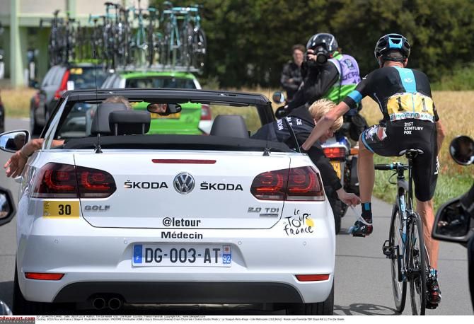 Chris Froome gets attended by race medics after a crash.