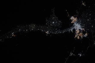 A string of dots showing the outline of the Nile river is seen across the dark surface of Earth