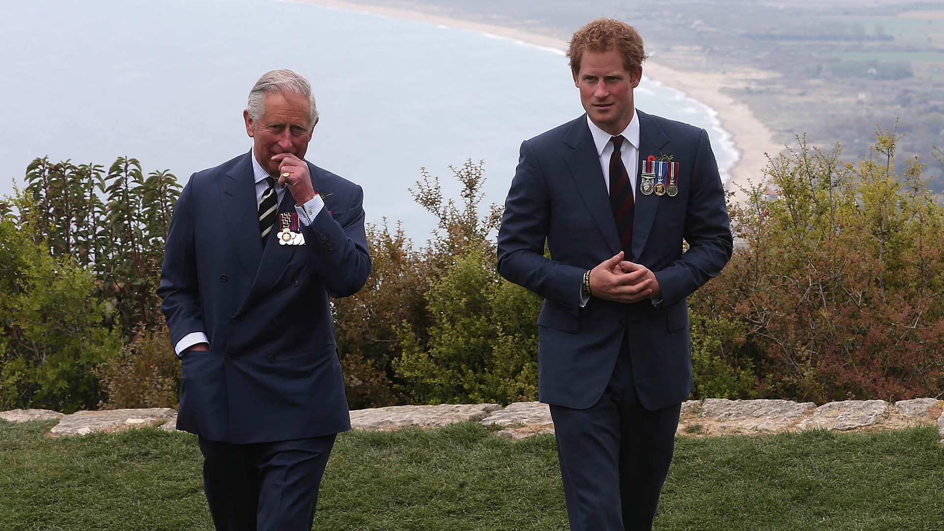 GALLIPOLI, TURKEY - APRIL 25: Prince Harry chats with Prince Charles, Prince of Wales during a visit to The Nek, a narrow stretch of ridge in the Anzac battlefield on the Gallipoli Peninsula, as part of commemorations marking the 100th anniversary of the Battle of Gallipoli on April 25, 2015 in Gallipoli,Turkey. Turkish and Allied powers representatives, as well as family members of those who served, are commemorating the 100th anniversary of the Gallipoli campaign with ceremonies at memorials across the Gallipoli Peninsula. The Gallipoli land campaign, in which a combined Allied force of British, French, Australian, New Zealand and Indian troops sought to occupy the Gallipoli Peninsula and the strategic Dardanelles Strait during World War I, began on April 25, 1915 against Turkish forces of the Ottoman Empire. The Allies, unable to advance more than a few kilometers, withdrew after eight months. The campaign cost the Allies approximately 50,000 killed and up to 200,000 wounded, the Ottomans approximately 85,000 killed and 160,000 wounded. (Photo by Niall Carson-Pool/Getty Images)