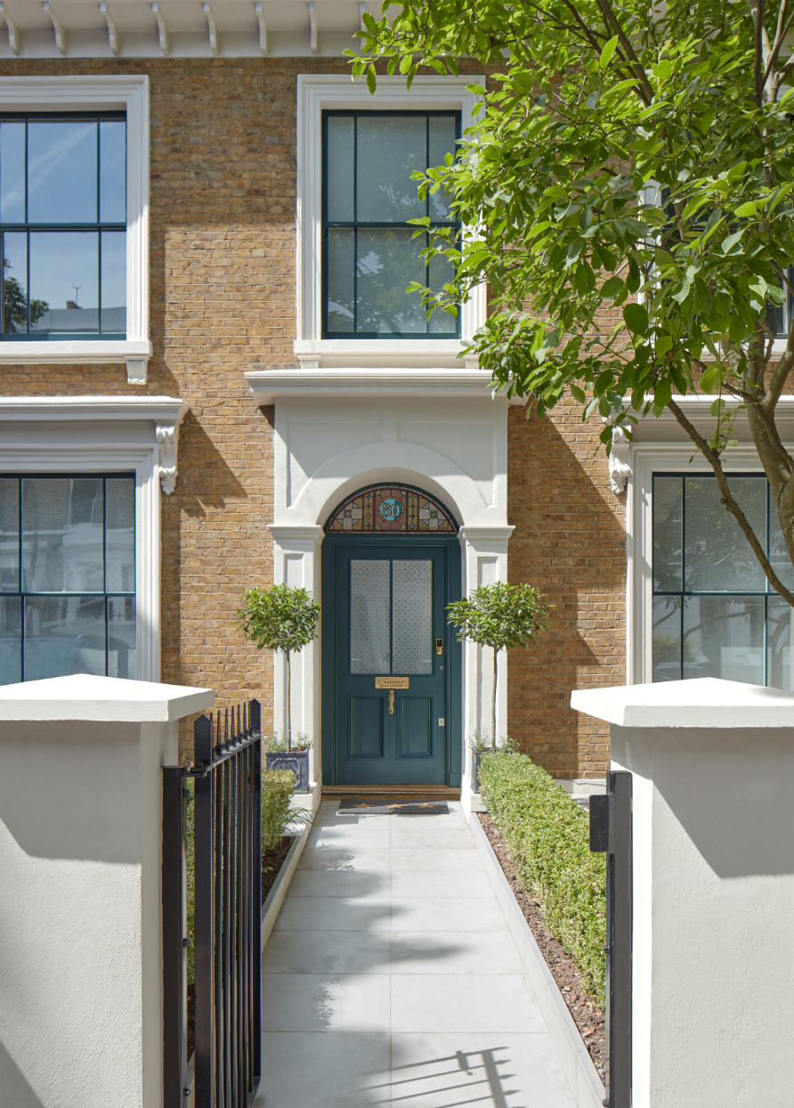 Teal front door and smart grey pathway on a Georgian property