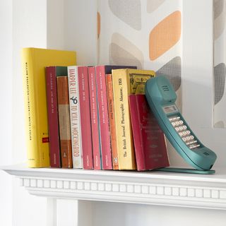books with shelves and wallpaper on wall