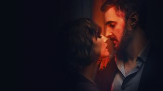 Obsession billboard - Anna and William sensually lean into each other as a red light shines on them 