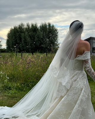 @livvperez wearing a lace wedding dress