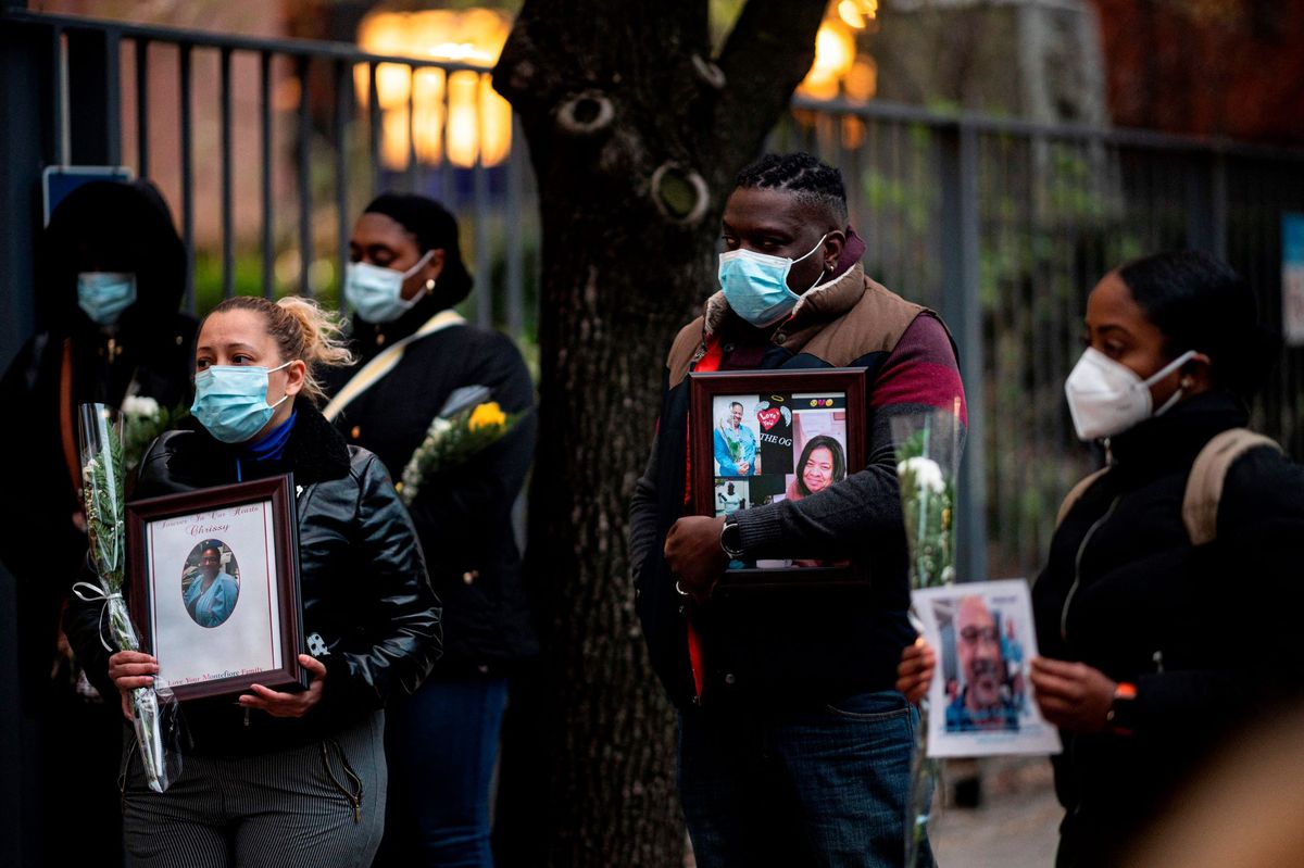 Nurses and healthcare workers mourn and remember their colleagues who died of COVID-19 during a demonstration outside Mount Sinai Hospital in Manhattan on April 10, 2020.