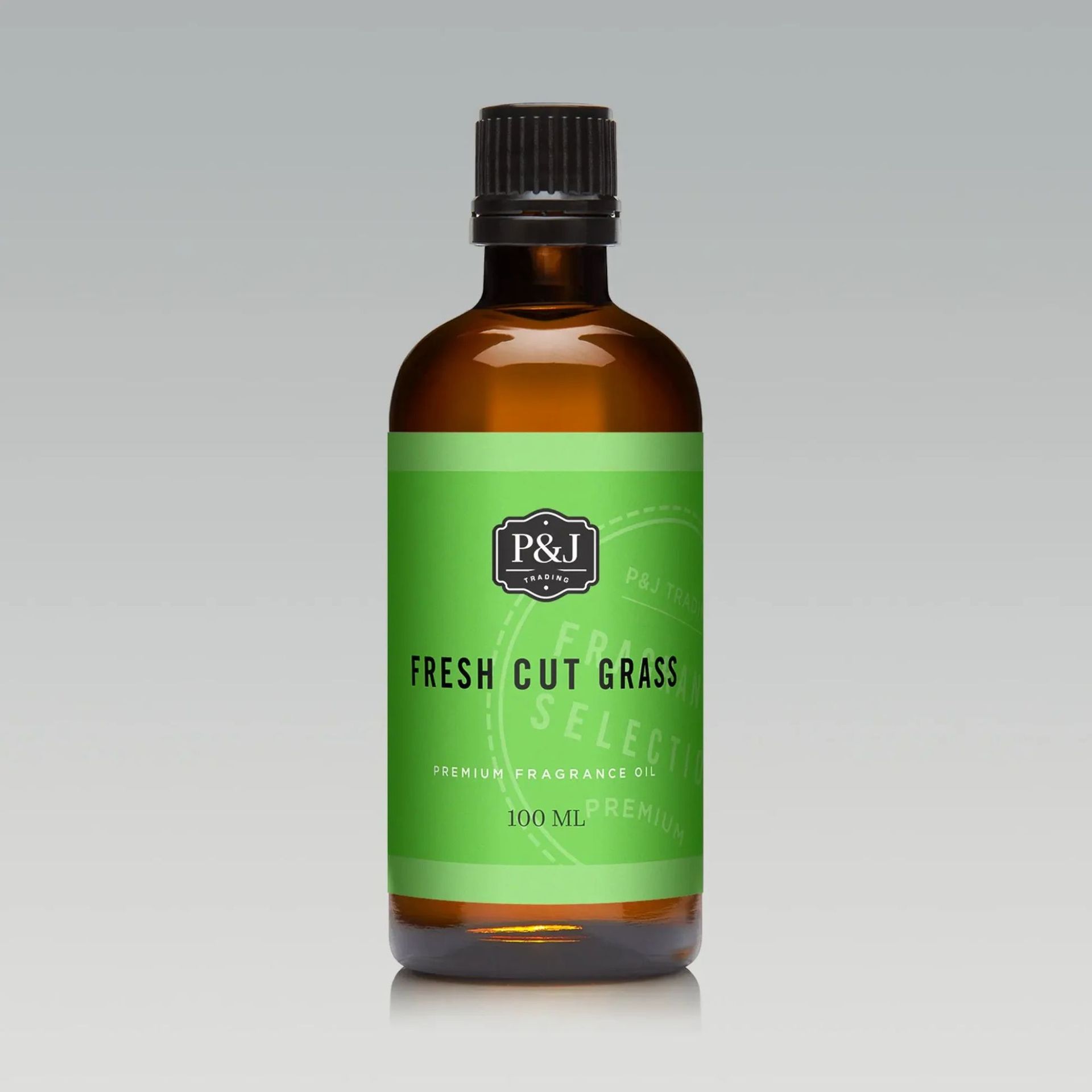 Fresh Cut Grass Essential Oils against a gray background.