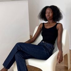 Sylvie Mus wearing a black tank top and jeans