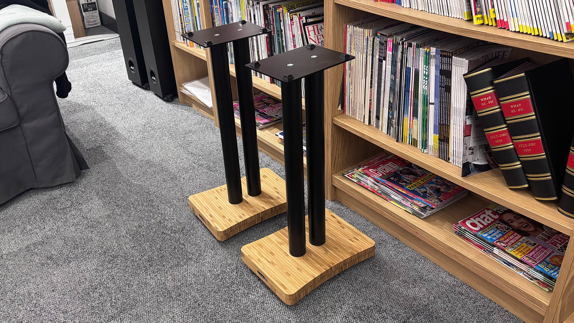 Atacama Moseco 6.2 speaker stands on grey carpet in front of bookcase