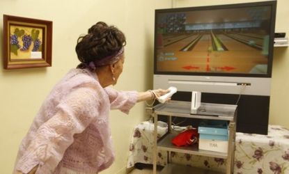 A senior citizen bowls with the Nintendo Wii: The Wii's once-unique motion-sensor console now faces tough competition from devices like Microsoft's Xbox Kinect.
