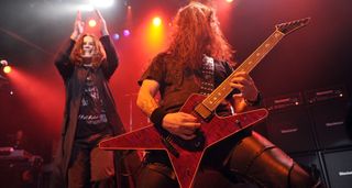 Ozzy Osbourne applauds as Gus G lets rip on his ESP signature model during his stint as the Prince of Darkness' guitarists.