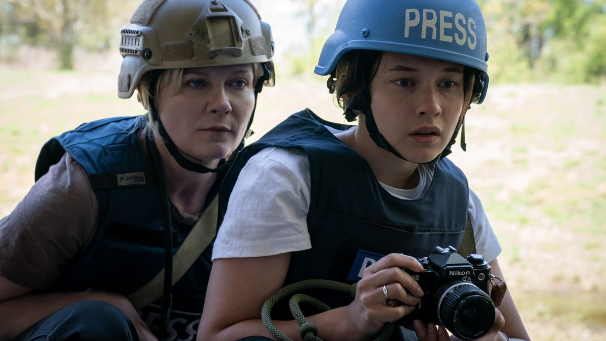 Still from the movie Civil War featuring Kirsten Dunst as a war photographer in combat gear