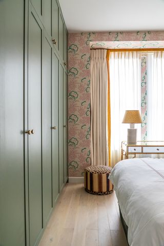 Green and pink bedroom with built in wardrobes