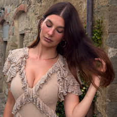 Camila Morrone wears a pink dress with ruffles to a wedding in Tuscany. 