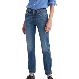 An image of a model wearing mid blue levi 50s and loafers against a white background