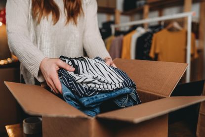 woman is preparing the shipment of some clothes