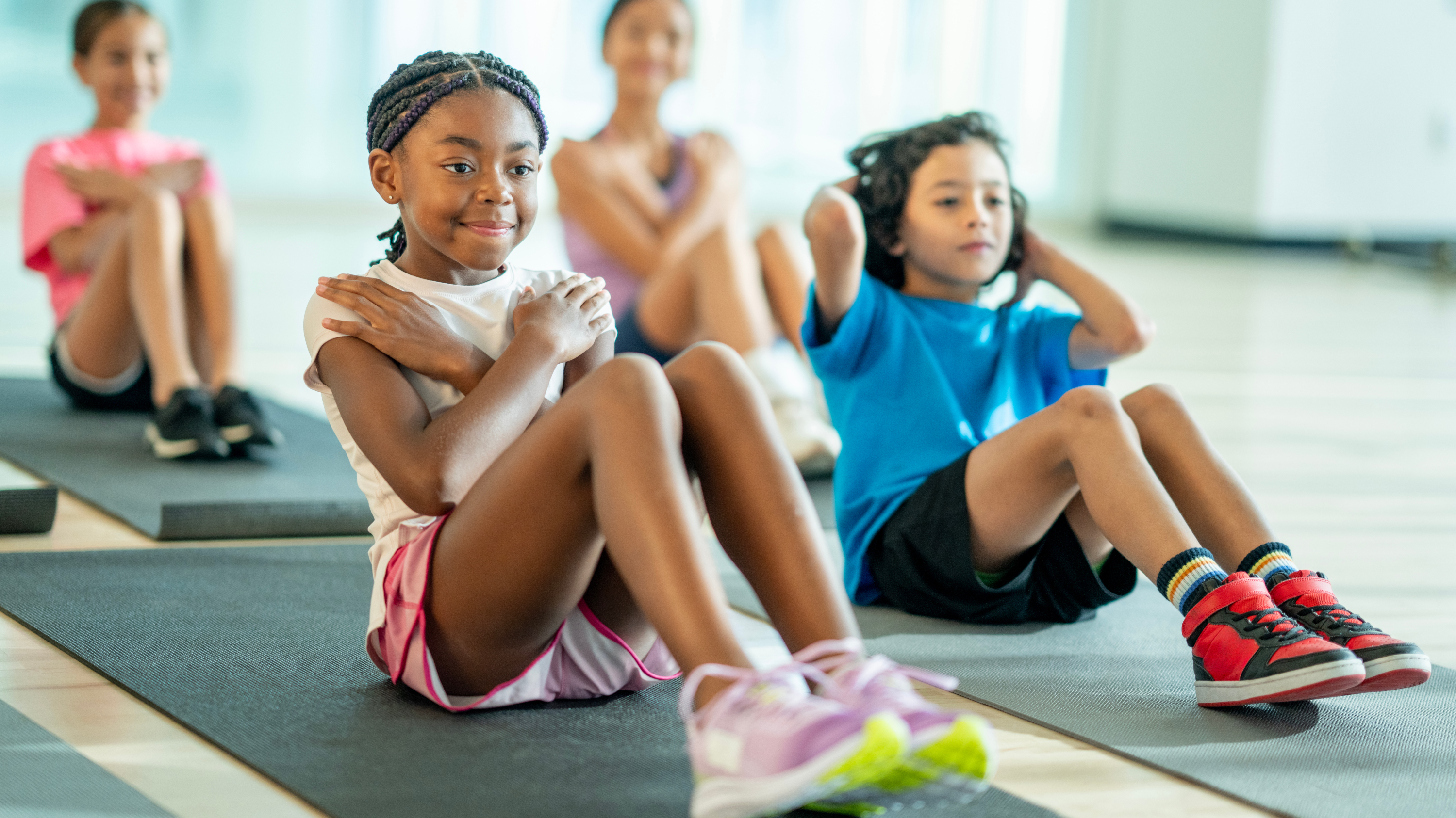 kids doing sit-ups on workout mats